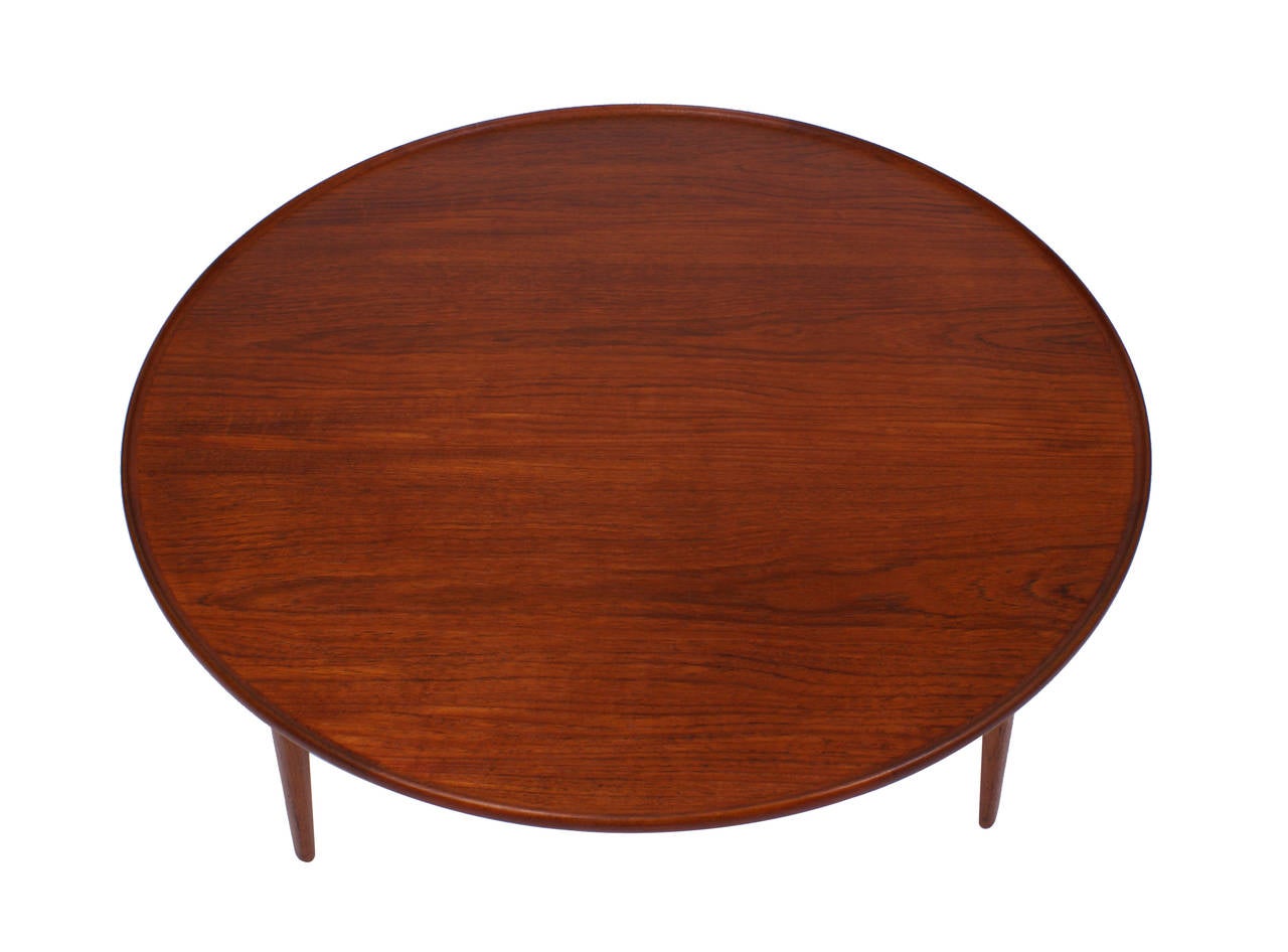 Circular teak coffee table mounted on three tapering legs. Model 1804. Designed 1953. Manufactured by Willy Beck with metal plaque.

Literature: Grete Jalk [ed.]: "40 Years of Danish Furniture Design", vol. 3, p. 237, 275.