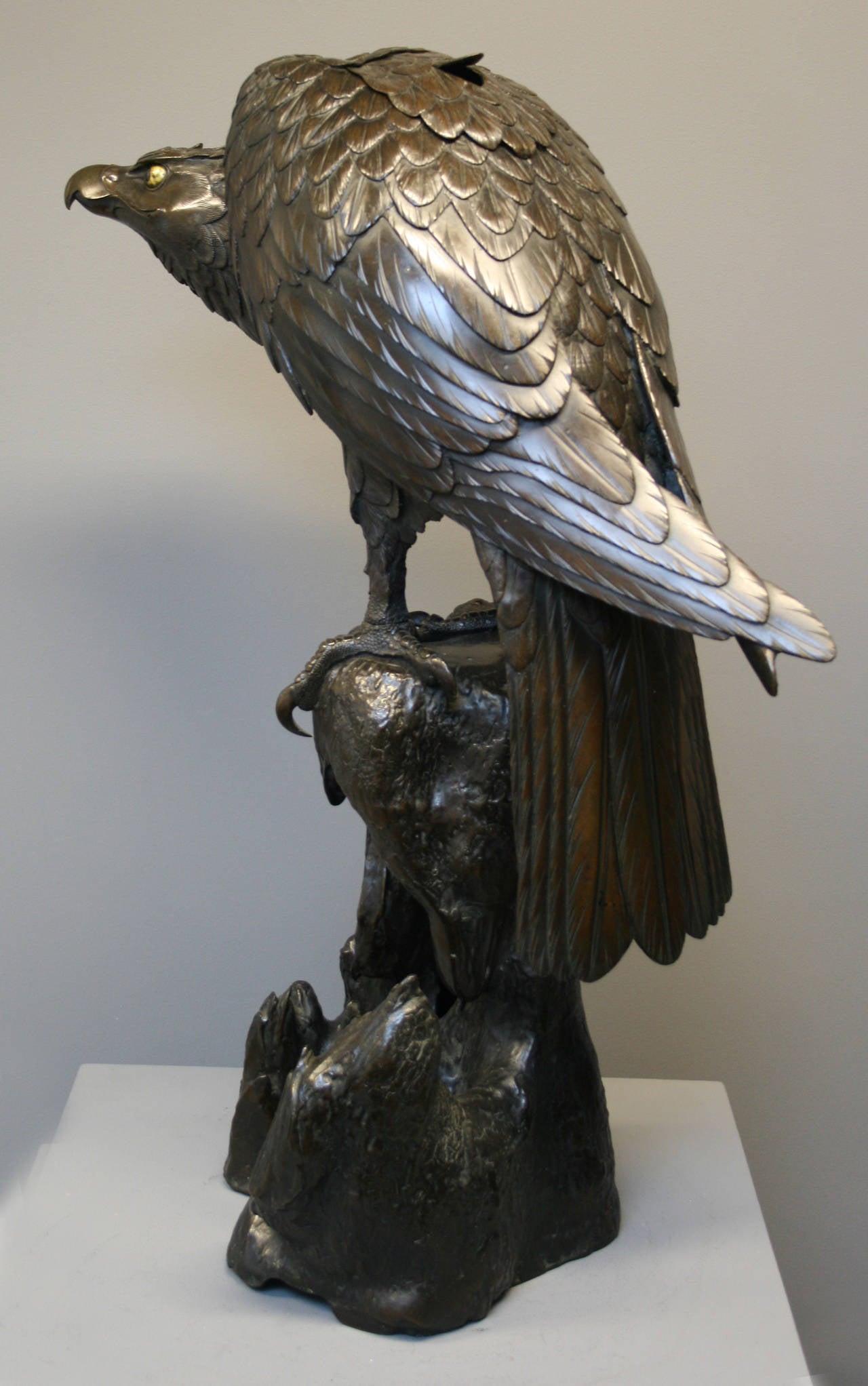 A very large Japanese bronze koro, or incense burner in the form of a hawk perched on a gnarled piece of wood. A back section of feathers lifts off to allow incense to be placed inside, you can see this in the fourth photo, one of the feathers is