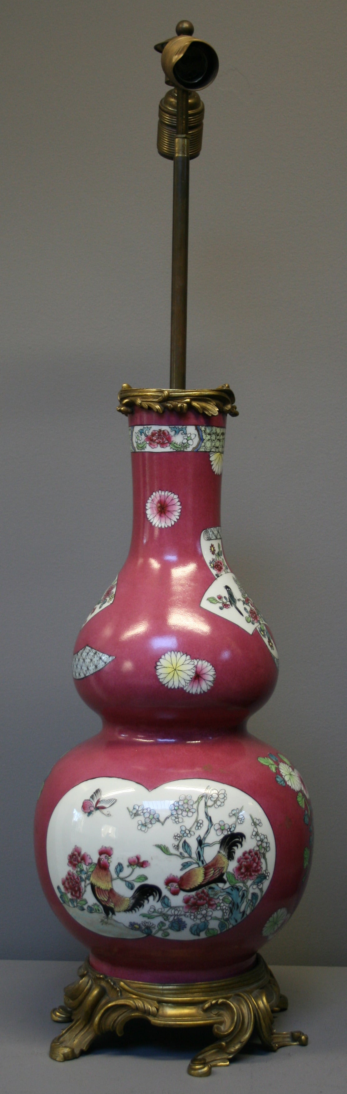A pink ground Chinese style famille rose vase decorated with flowers and  panels of cockerels. There are ormolu lamp fittings for two lightbulbs, this will need rewiring. 

Samson and company were a French specialist firm founded in Paris in the