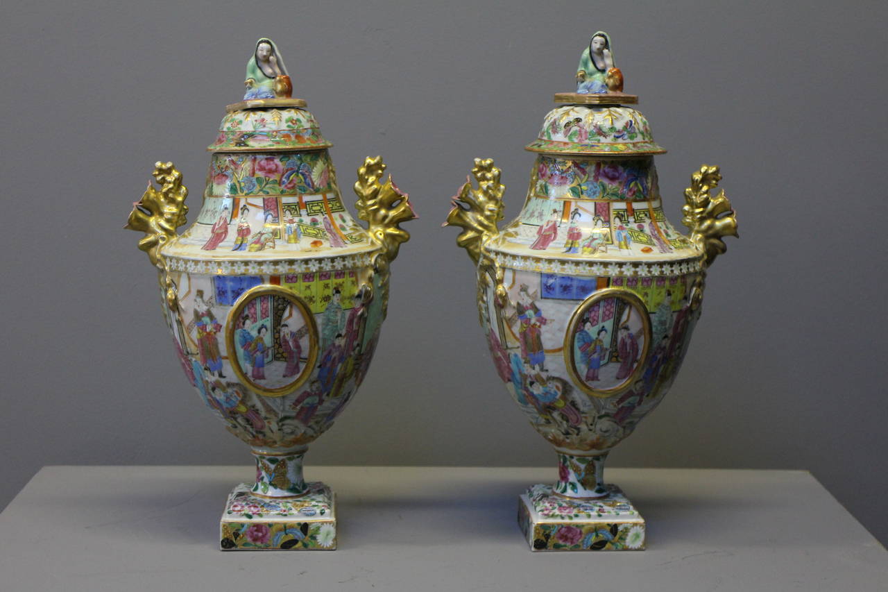 A pair of Chinese Cantonese vases with elaborate handles and a lady figure forming the knop of the vase.

(Buyers in the UK or Europe will be subject to +VAT)