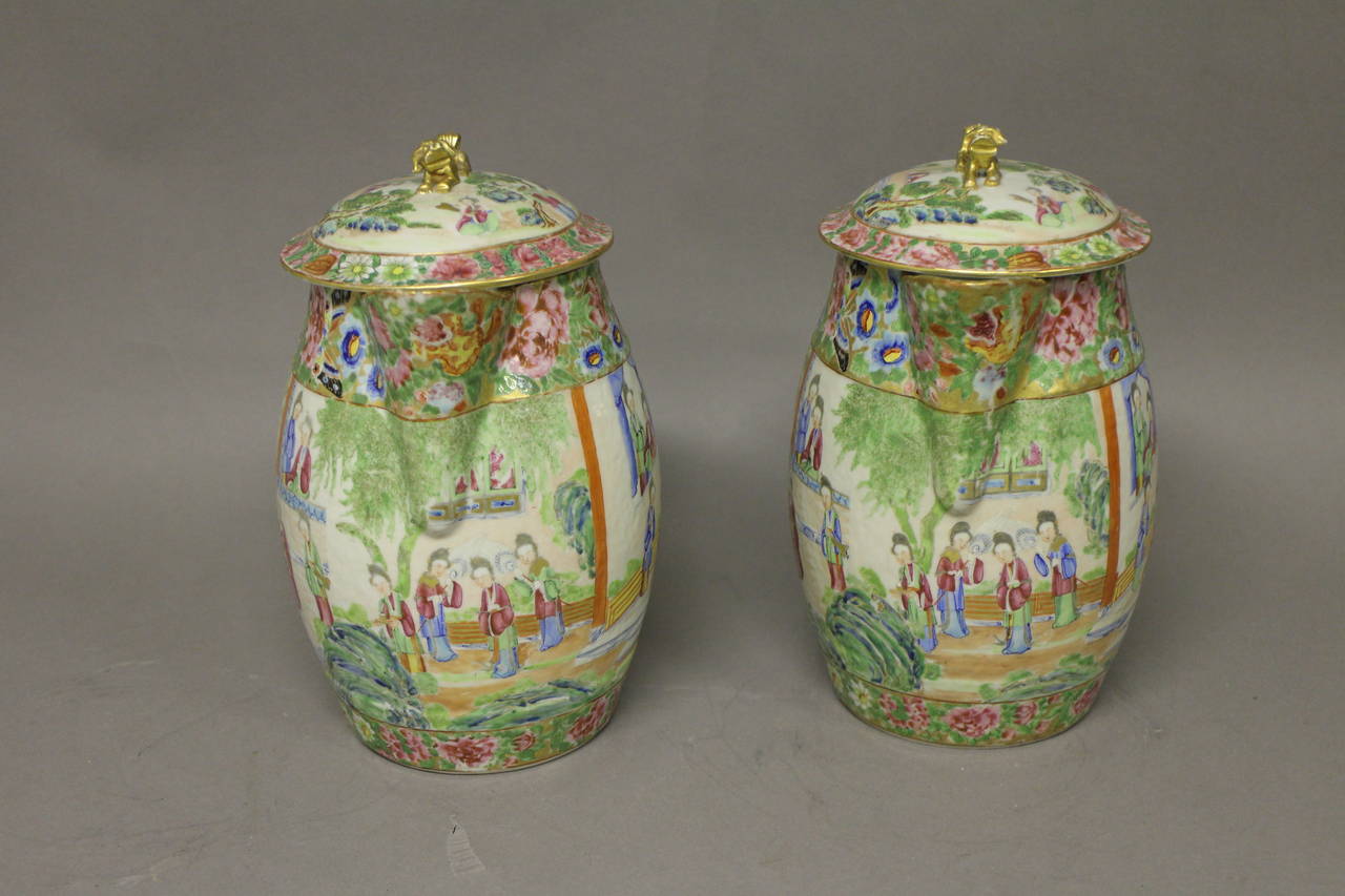 A pair of Chinese Cantonese jugs and covers, decorated with a floral design and panels of noble ladies. 

(Buyers in the UK or Europe will be subject to +VAT).