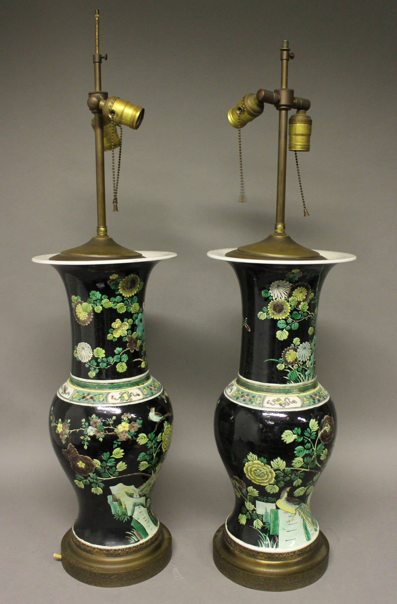 A pair of Chinese famille nior lamps, decorated with a scene of birds in a forest. The lamp fittings are included, but will need rewiring. 

Height of vases 17.5