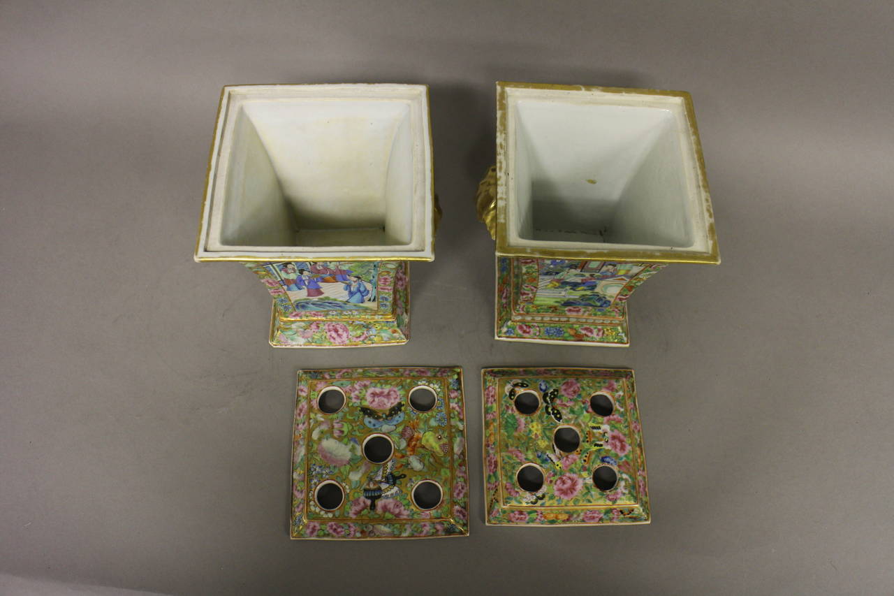 A matched pair of Chinese Cantonese bough pots and covers with gold handles, decorated with a floral butterfly design and panels of everyday pursuits.

(Buyers in the UK and Europe will be subject to +VAT).