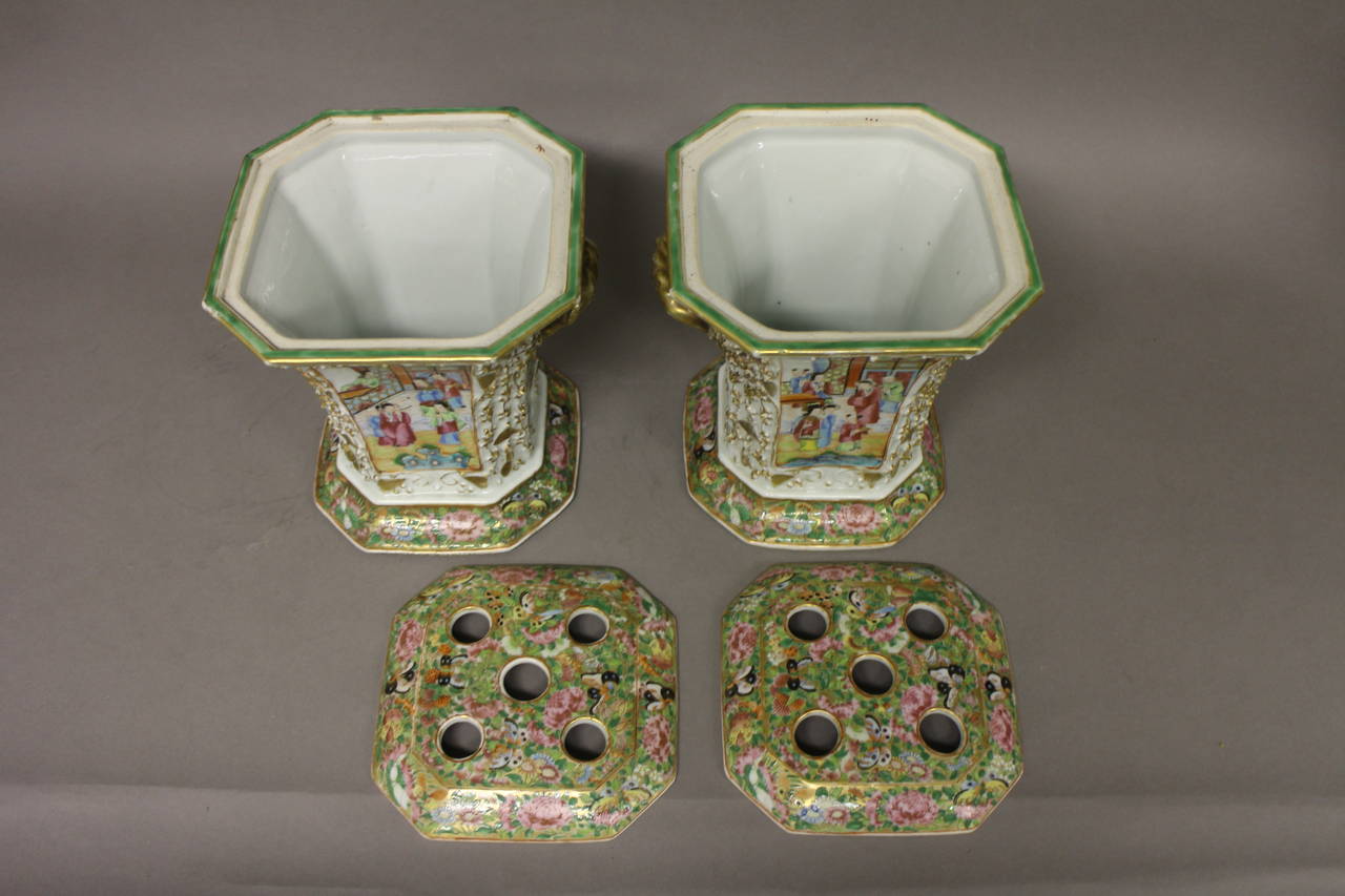 A pair of Chinese Cantonese bough pots and covers, decorated with a floral design and panels of everyday pursuits.

(Buyers in the UK and Europe will be subject to +VAT).