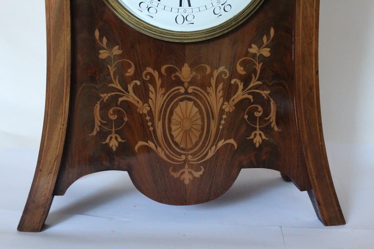 This French, eight-day movement clock will strike hours and half hours on a gong. The very crisp enamel dial showing both Arabic and roman numerals. The wonderful mahogany case has intricate inlay which adds great interest to the case and colour