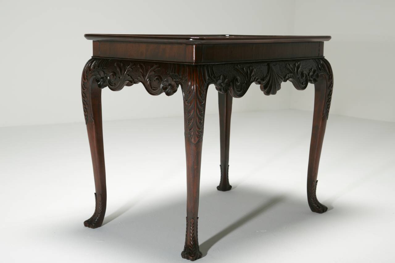An elegant and distinctively “Irish” dished top silver table or centre table in a style often incorrectly referred to as “Irish Chippendale” because the style was used in Ireland prior to Chippendale.  The frieze is carved in the finest low relief