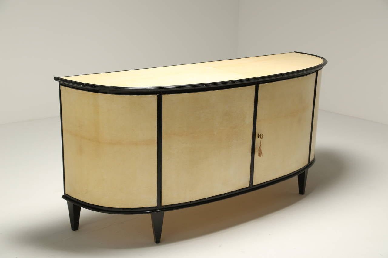 European An Italian Parchment Covered and Ebonised Demi-Lune Sideboard