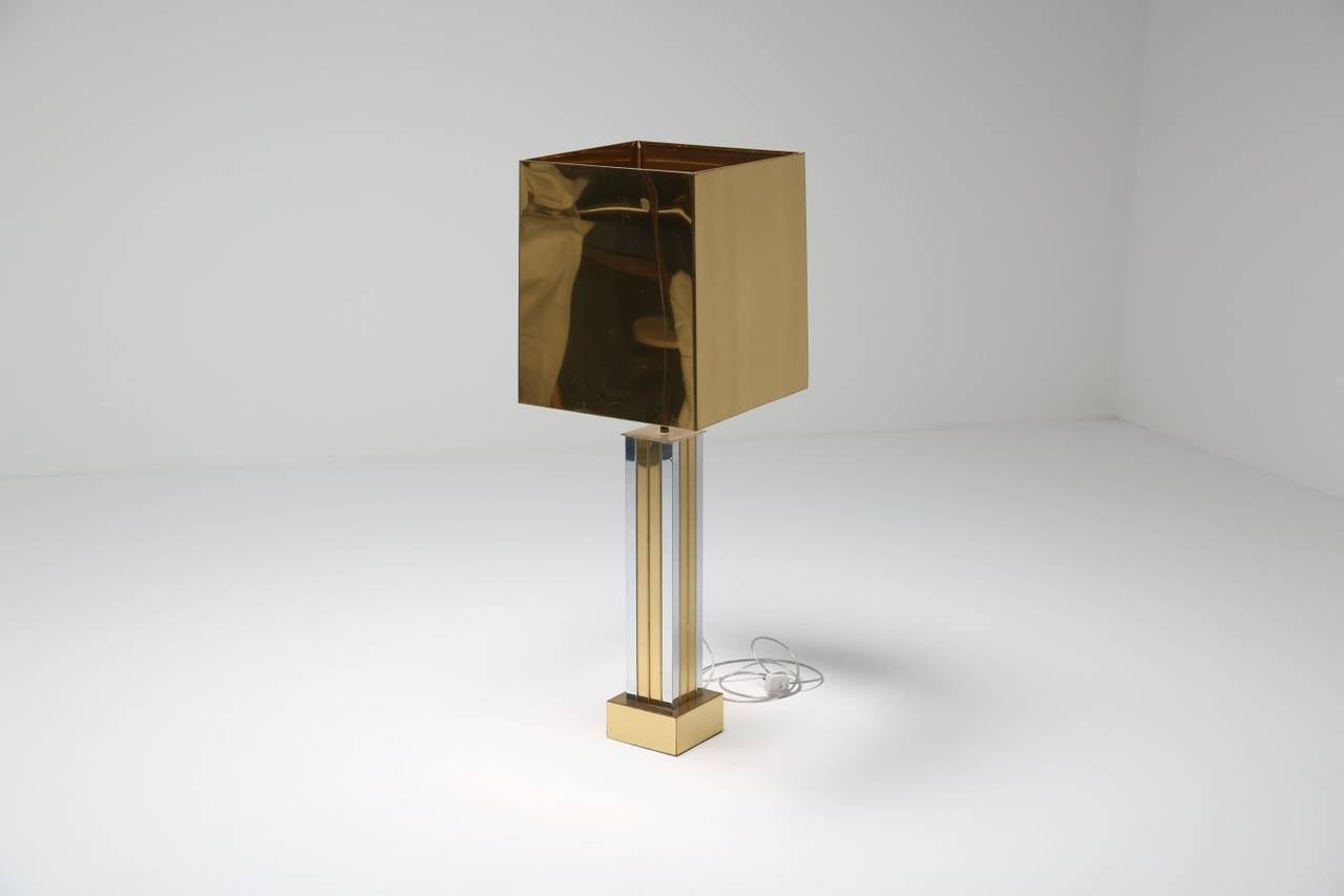 Huge table lamp with a chrome and brass skyscraper style body and an all brass shade. Very impressive lamp due to its scale and design, see the image of the lamp beside a normal sized armchair to get an impression of the size of it. The base is