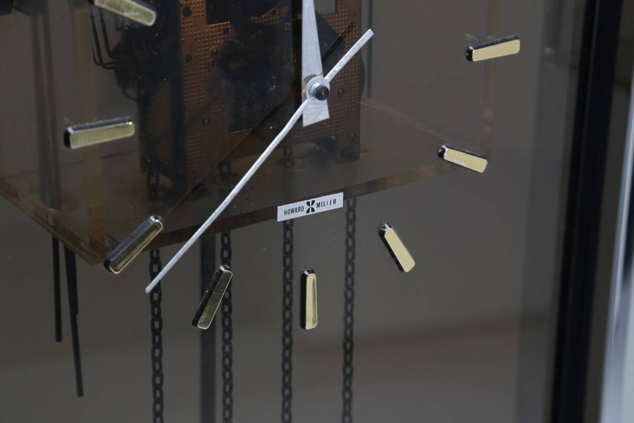 Chrome grandmother clock made by the Howard miller clock company probably designed by Arthur Umanoff. Chrome body with a long smoked perspex panel and metal clock hands sprayed silver. Fully working condition,Beautiful piece of mid-century American