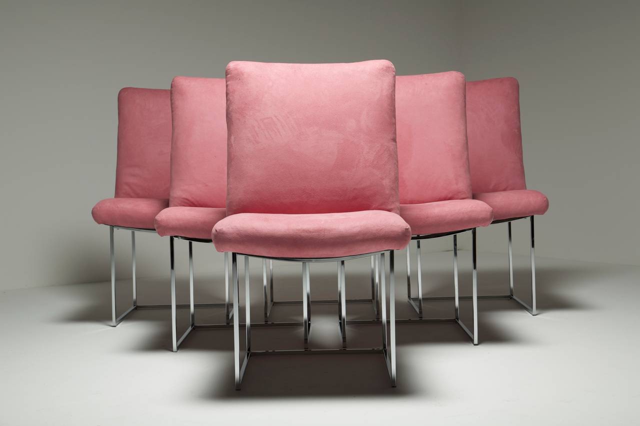 A set of six chrome frame Milo Baughman dining chairs covered in a pink ultrasuede fabric. All chair frames are in excellent condition and the current fabric is usable as is but can easily be replaced. We have 6 more matching chairs that all need to