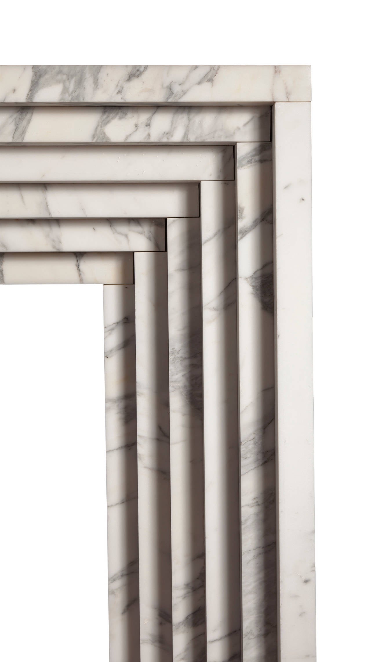 A marble fireplace with receding rectangles in the Art Deco style. A style which flourished internationally during the 1930s and 1940s.

This fireplace can be made to size and from a choice of different marbles.

Example in photograph is Carrara
