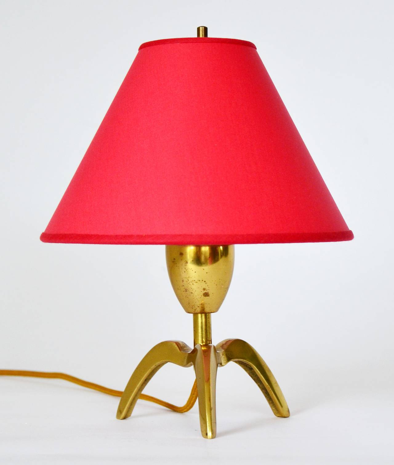 A very charming Viennese table light from the 1950s. Nice patina on brass.
It is rewired, renewed red lampshade.