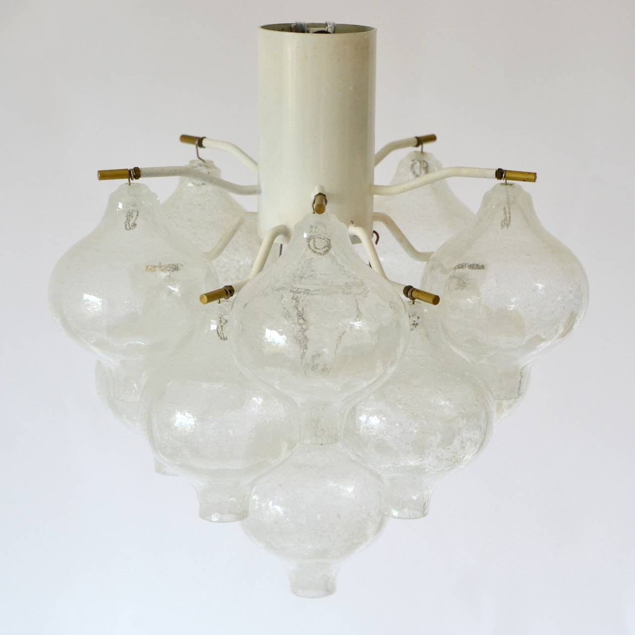 Glass light fixture by J.T. Kalmar from the 1960s. The hardware is made of brass and white lacquered metal. It holds 11 handblown glasses and has one socket for a E27 bulb.

We ship worldwide.