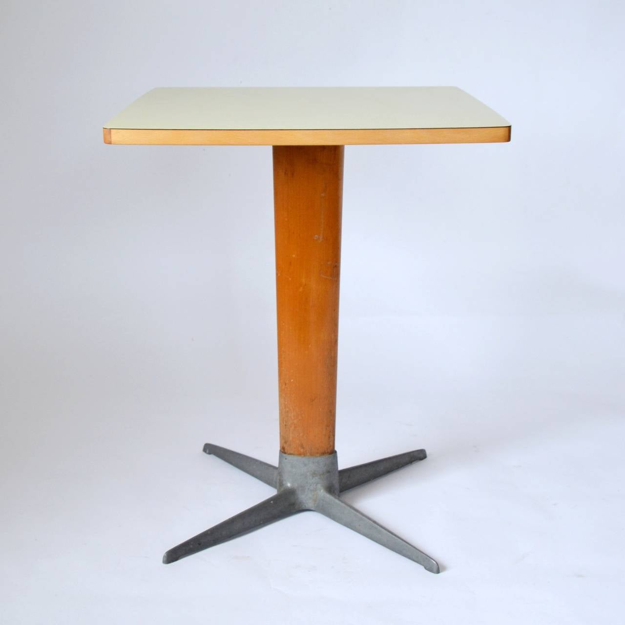 A Viennese coffee house table, designed by the Austrian architect Prof. Oswald Haerdtl and produced by Thonet, Austria, 1950s. Typical Haerdtl X-base made of metal with a stand made of beech. Beech top laminated with original formica. 

Vintage