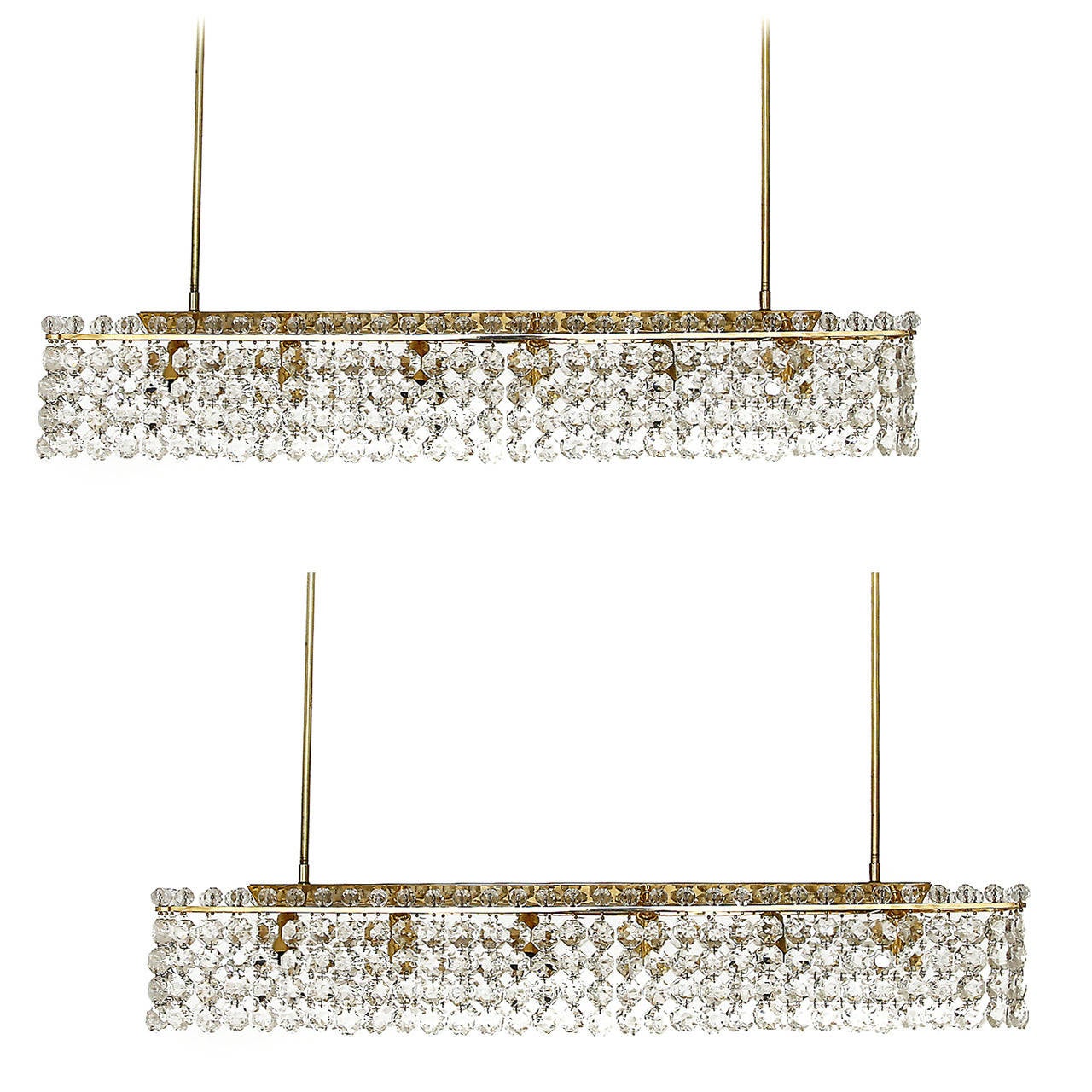 Two large and high quality chandeliers / pendants by Bakalowits & Soehne, Austria, Vienna, 1960's. These glamorous lights are made of box brass frames decorated with hangings of hand cut diamond shaped glass crystals. Large crystal glass pearls