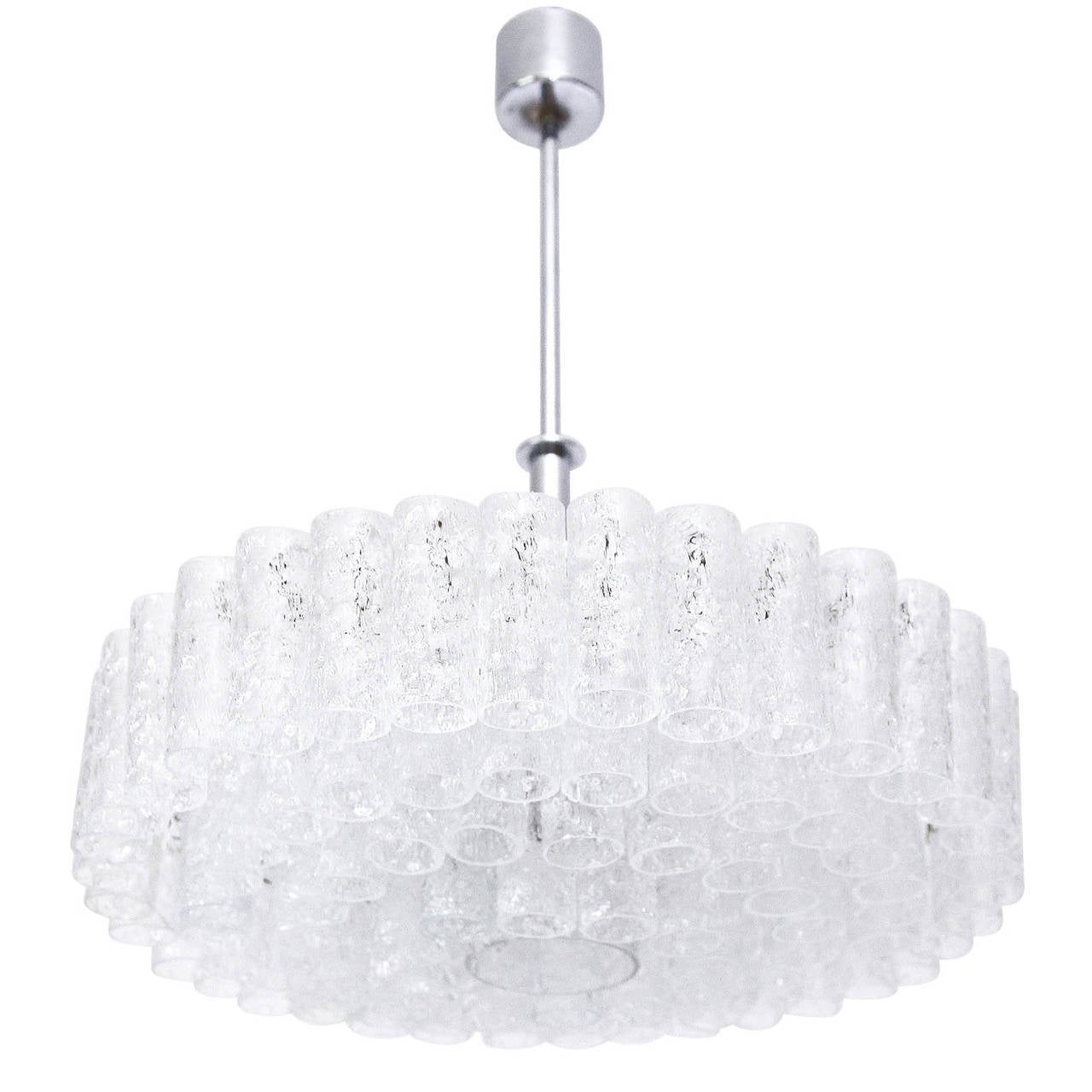 Beautiful five thier chrome and glass chandelier by Doria, Germany, manufactured in Mid-Century. Many frosted ice glass tubes in different lenghts hang on a white lacquered frame.

The lamp works on 220V as well as on 110V. It takes eight small