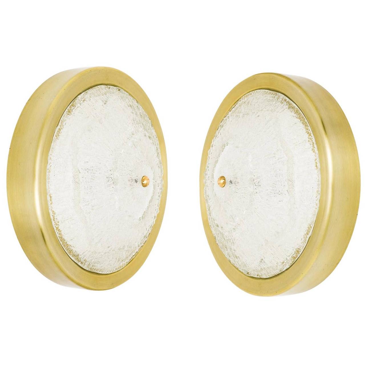 One of two beautiful frosted glass light fixtures by Kalmar. A thick textured glass is mounted with a brass bolt on a matte finished brass-plated backplate. The light can be used as ceiling or as wall lamp.
The price is per fixture. They are sold