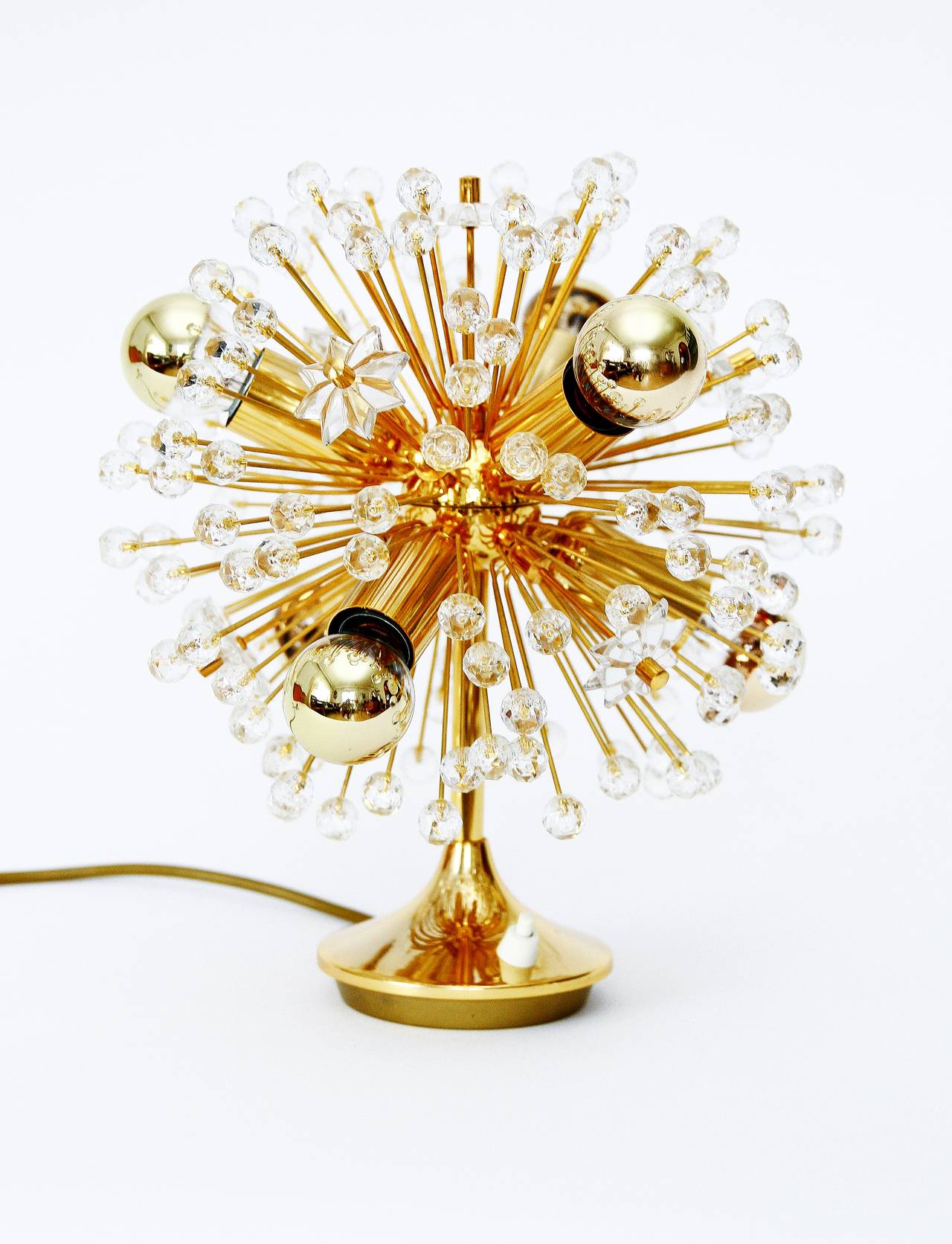 Beautiful pair of sputnik table lamps designed by Emil Stejnar and executed by Rupert Nikoll Vienna. Very exclusive 24 carat gold-plated version with a lot of Austrian crystal balls and stars. Excellent condition.

The price is per item. They are