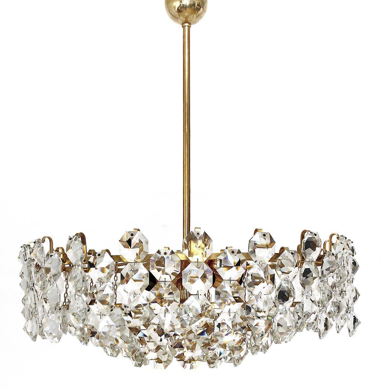 A large and very beautiful Austrian chandelier manufactured in Mid-Century in the 1960s. It is made of large cut crystal glass and a brass frame. Each crystal glass has the dimensions of 2.4 x 2.4 in. (6 x 6 cm). This kind of diamond shaped crystal