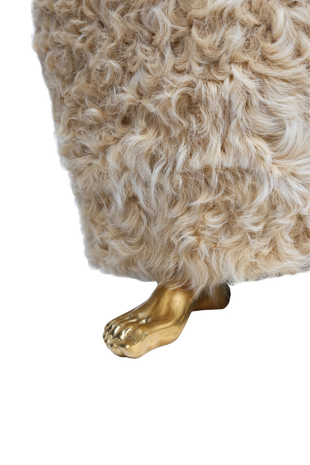 The Foot Stool is handmade from a seat of luxurious shearling mounted atop solid bronze cast feet. Unexpected and eye-catching, it is perfect as an ottoman or petite seating at a vanity or console.