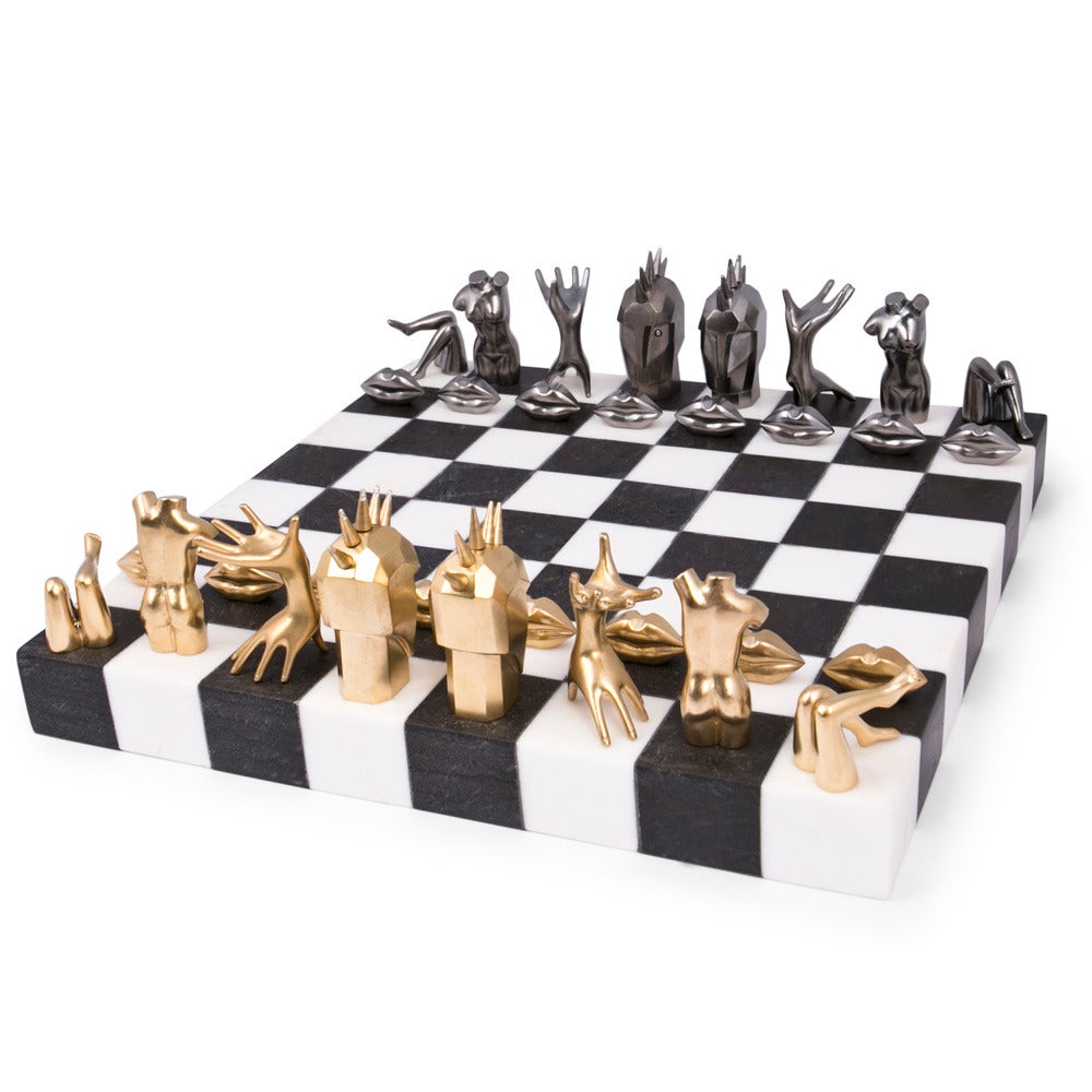 The Limited Edition Dichotomy Chess Set features 22k Burnished Gold Plated and Gunmetal Plated Bronze pieces inspired by Kelly Wearstler’s signature figural object d’art. The King and Queen pieces are adorned with diamonds, and the solid board is