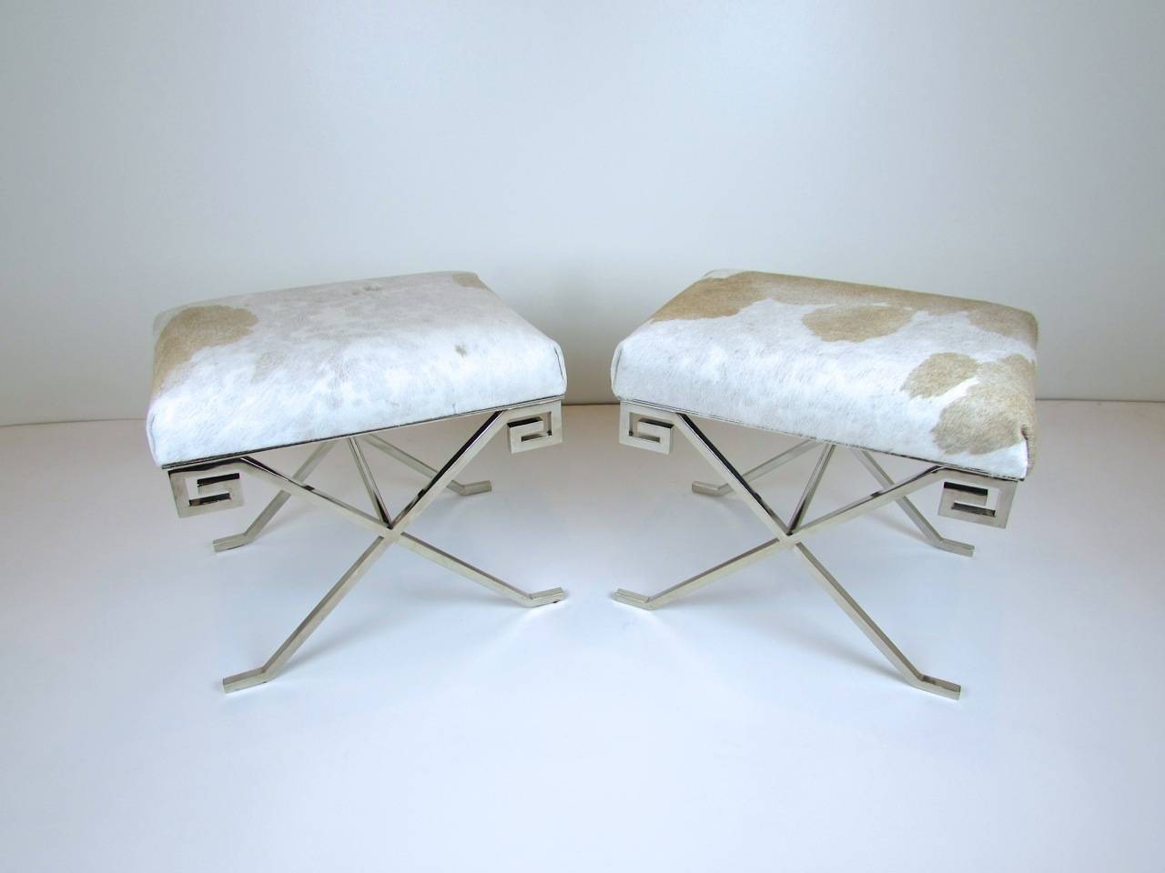 Pair of nickel plated and pony hide Greek Key stools.