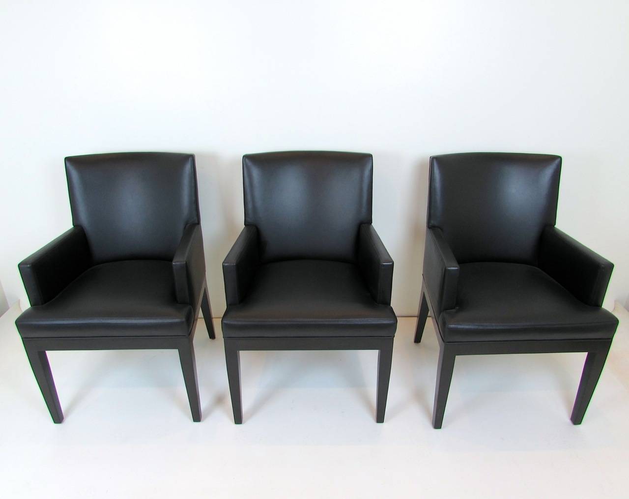 Set of six black leather dining armchairs by A. Rudin. Arm height: 26