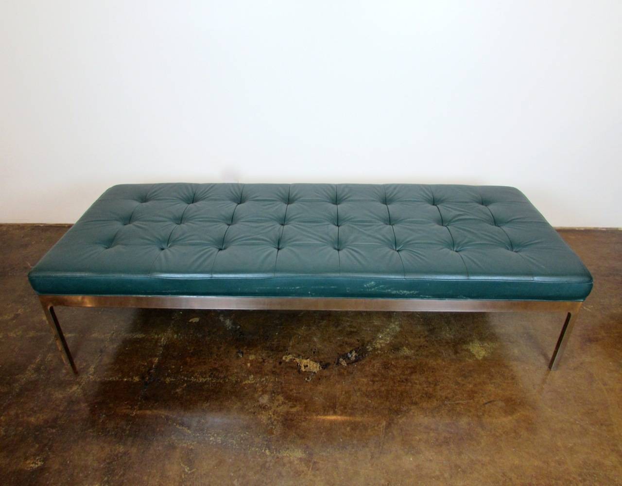 The Three Bench by Nicos Zographos in polished stainless steel and button tufted leather.