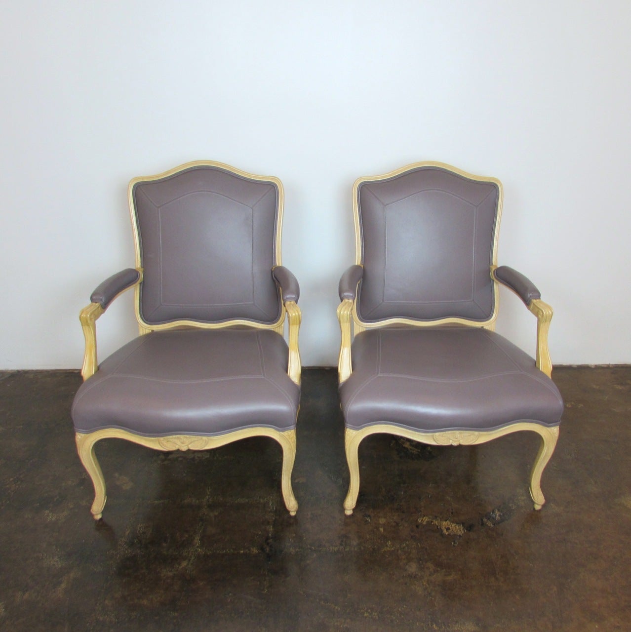 Pair of leather Villa Fauteuil arm chairs designed by Sally Sirkin Lewis for J. Robert Scott.
