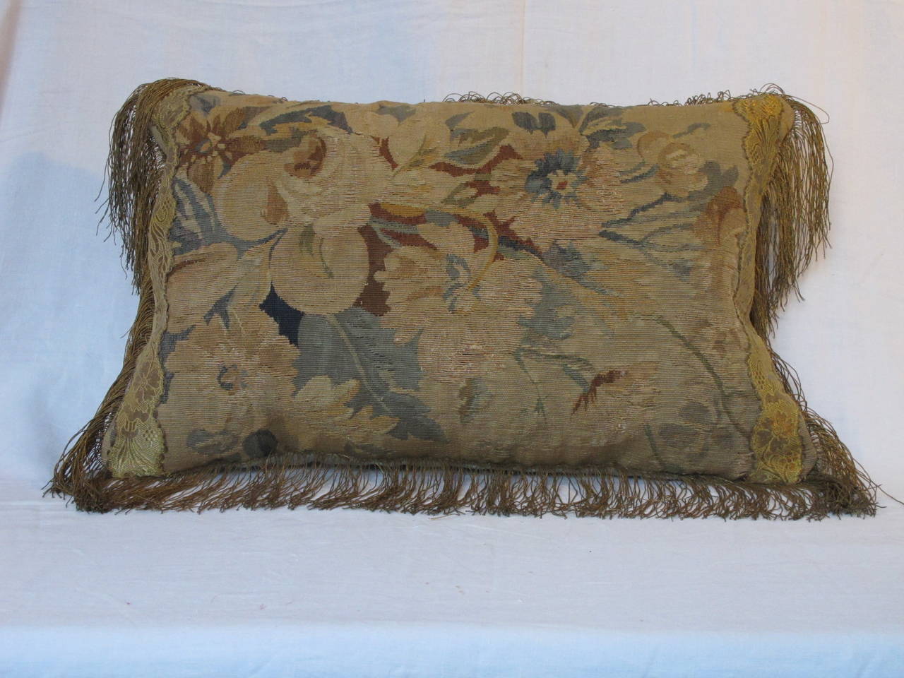 Newly made pillow from an Aubusson Fragment, embellished with antique metallic trims, backed with a coordinating silk velvet.