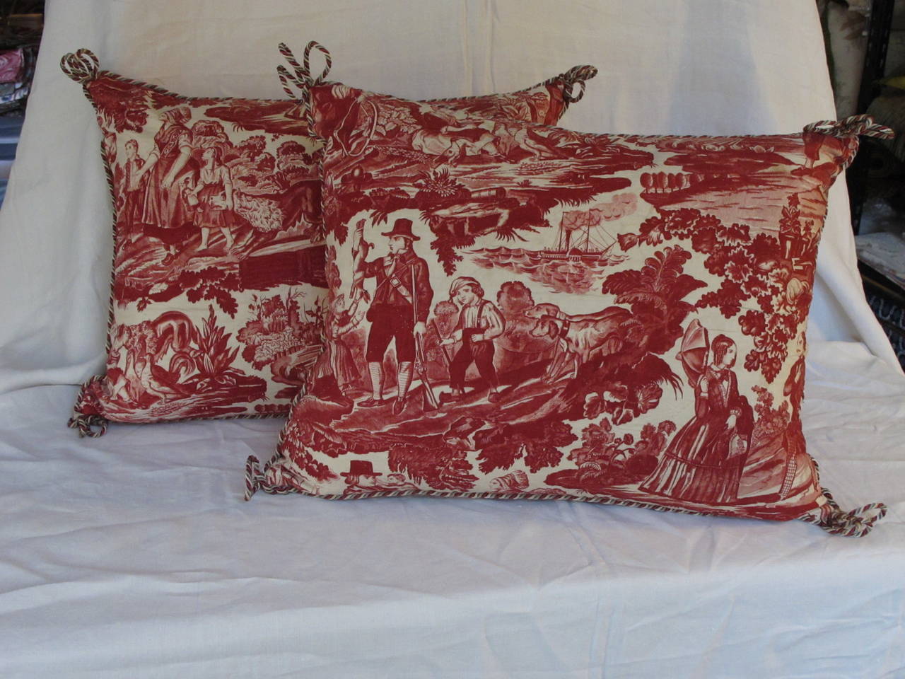 Newly made pillows from an early hand quilted toile de jouy backed with antique French ticking, includes a down insert.