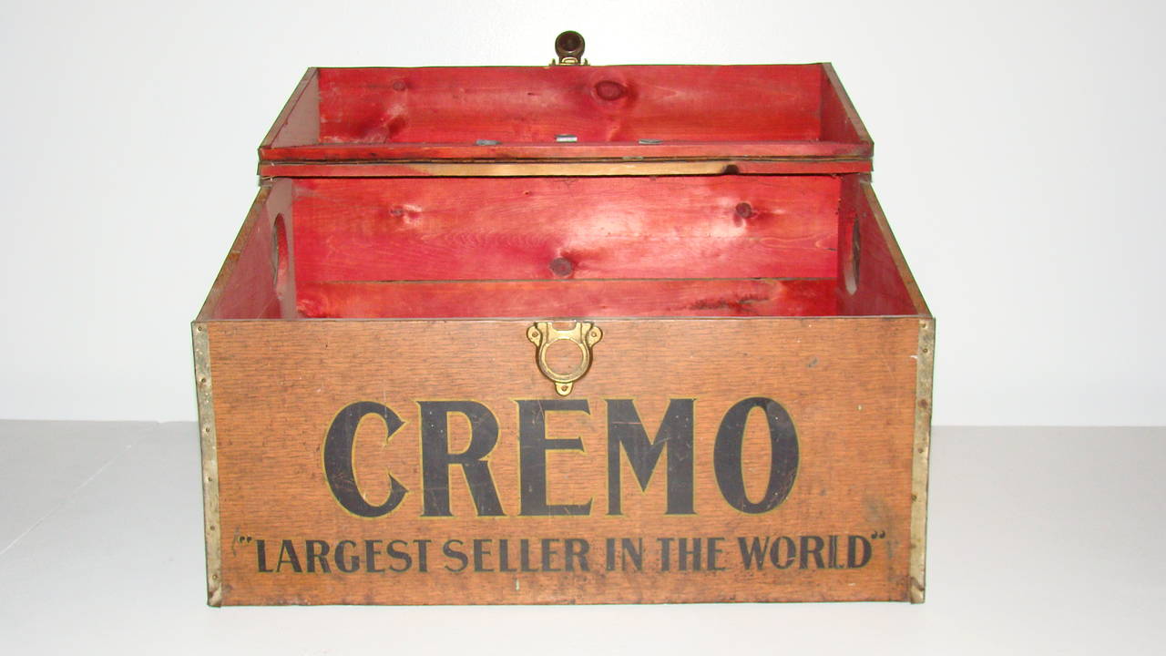 Early Cremo cigar humidor.  These trunks were used to ship cigar boxes to the distributors.  The chest itself is wood encompassed in an oak lithographed tin.  The handles, lock and vents are all original and intact.  Although it claims to 