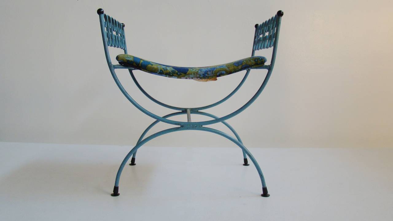 Solid Wrought Iron, Upholstered Window Seat or Vanity Bench designed by Arthur Umanoff retains original deep ocean blue enamel paint, floral fabric upholstery, black plastic finials and glides. The Grenada Series.