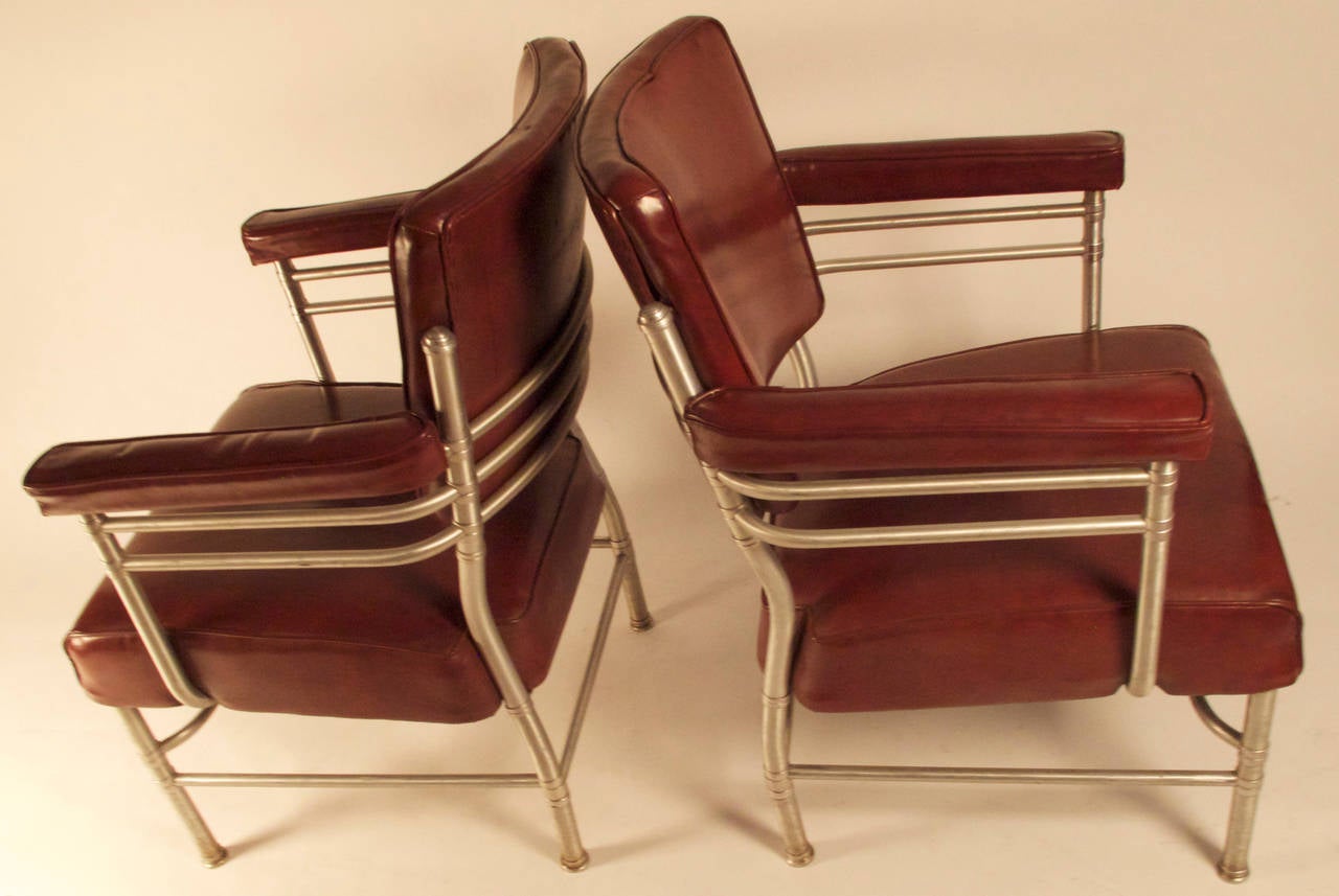 A rare pair of Warren McArthur armchairs in the original red vinyl upholstery.