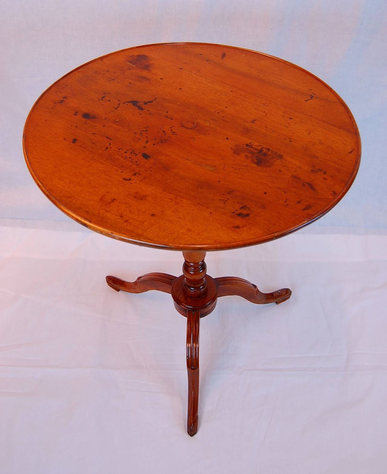 This period circular table was possibly made as a tilt-top, but has since been glued solid. Table is solid without staining or flaws, in original finish.