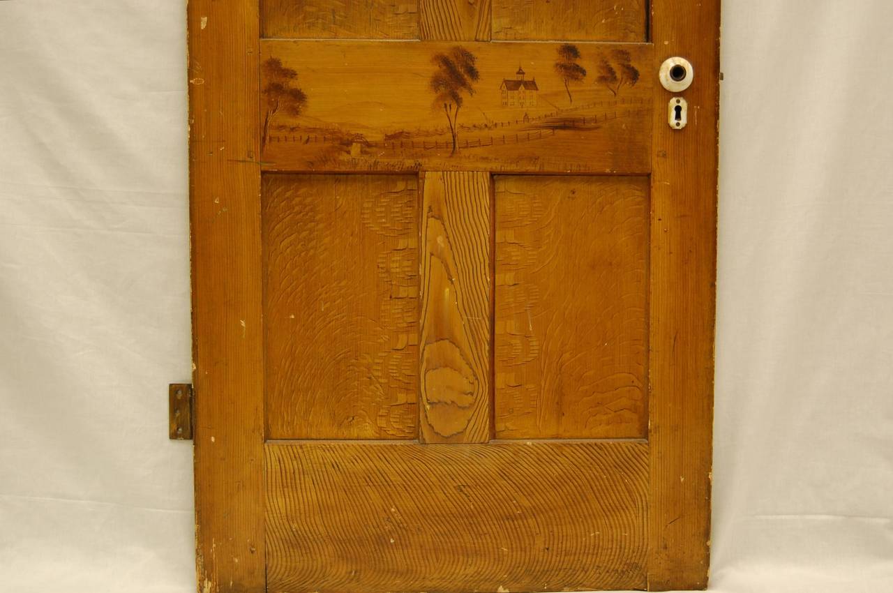 Early Pennsylvania pine door with mortise and tenon joinery. Faux wood finish as well as hand drawn country school scene. Construction and joints are tight.