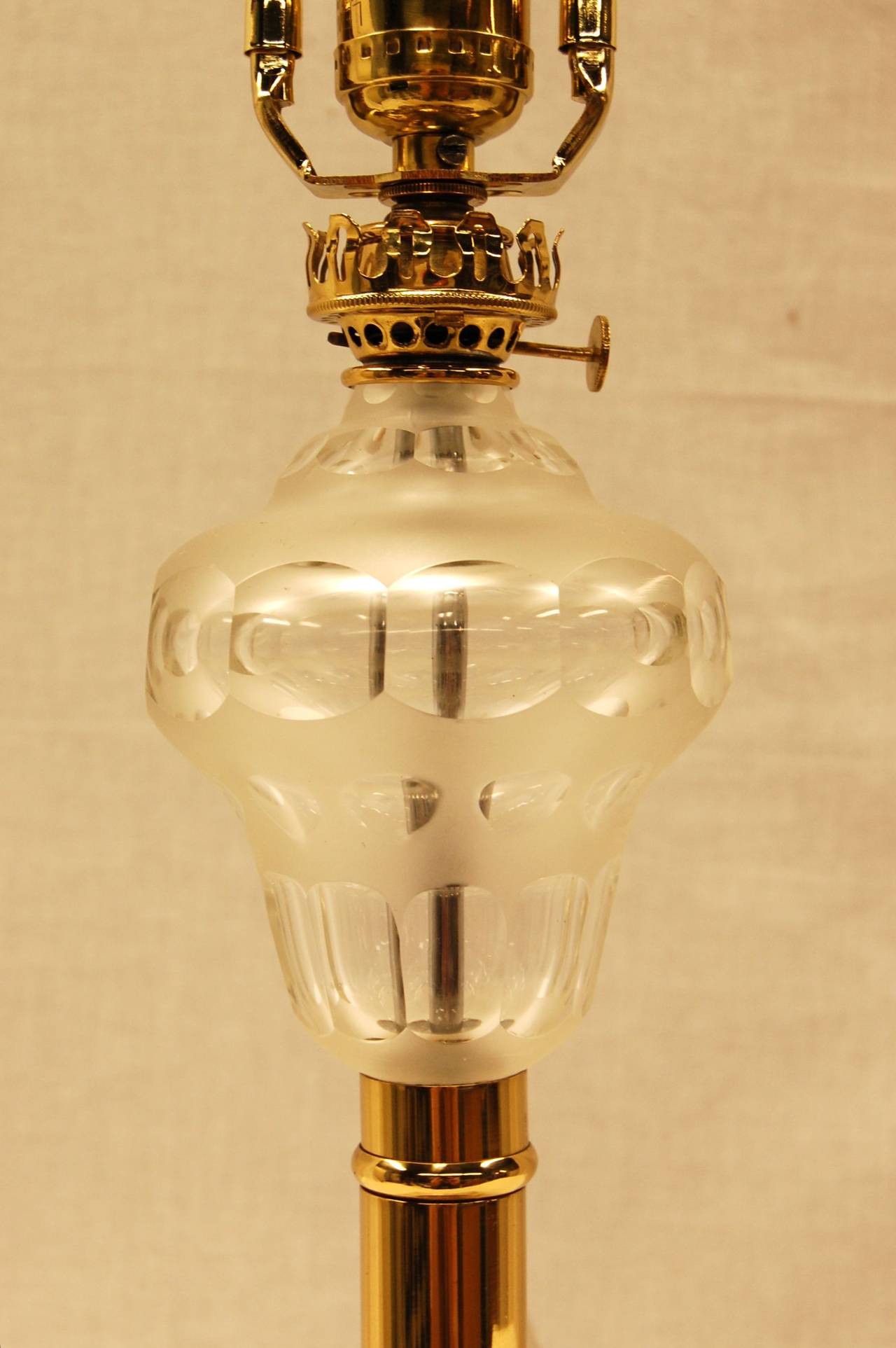 This American oil lamp has a beautiful cut and frosted glass font, and rests upon a brass column and marble base. Wired with a single switch mounted on the wire. 10 3.4