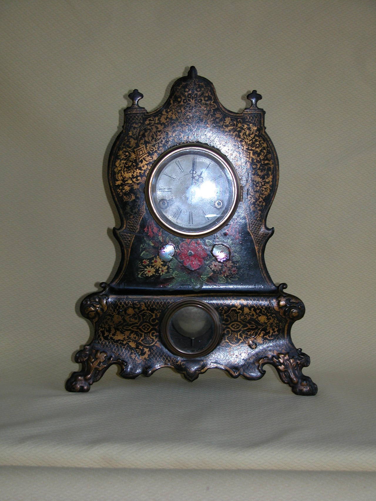 Pretty mantel clock in excellent condition. The key turns but we haven't attempted to actually make it run and chime. The mother-of-pearl inlay and painted decorations are intact and very brightly painted.