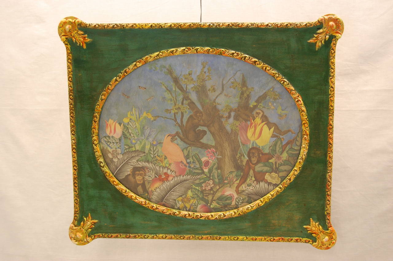 Whimsical framed jungle scene made of 19th century cut-out fabric, painted with monkeys and plants. 20th century paper cut-outs of birds and flowers were then added. The frame is brightly colored and works well with this piece of artwork.