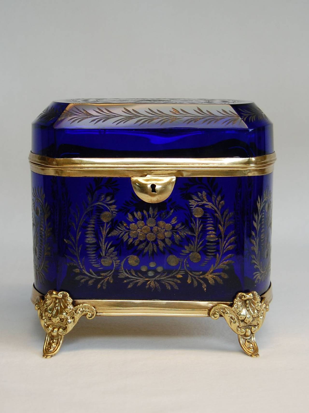 Large antique cut glass lidded box, likely by Moser, 1880s. Beautifully cut floral design with much of the original gilding remaining. Metal is in bright gold finish, hinge and framework are all tight, key is missing.