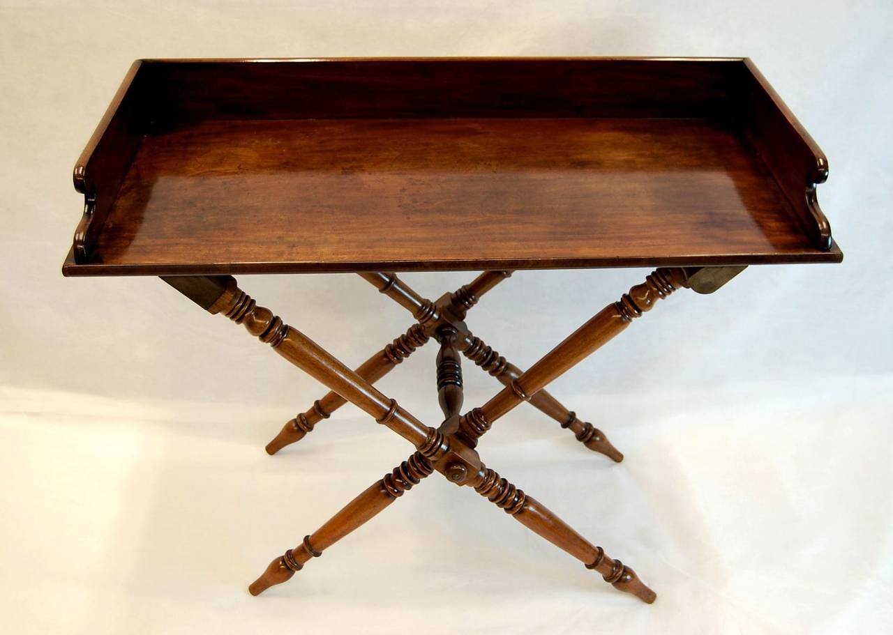 Large, beautiful and useful mahogany serving tray table on a tall X-frame folding base. We just cleaned and polished the finish, leaving a wonderful lustrous table, circa 1860.
