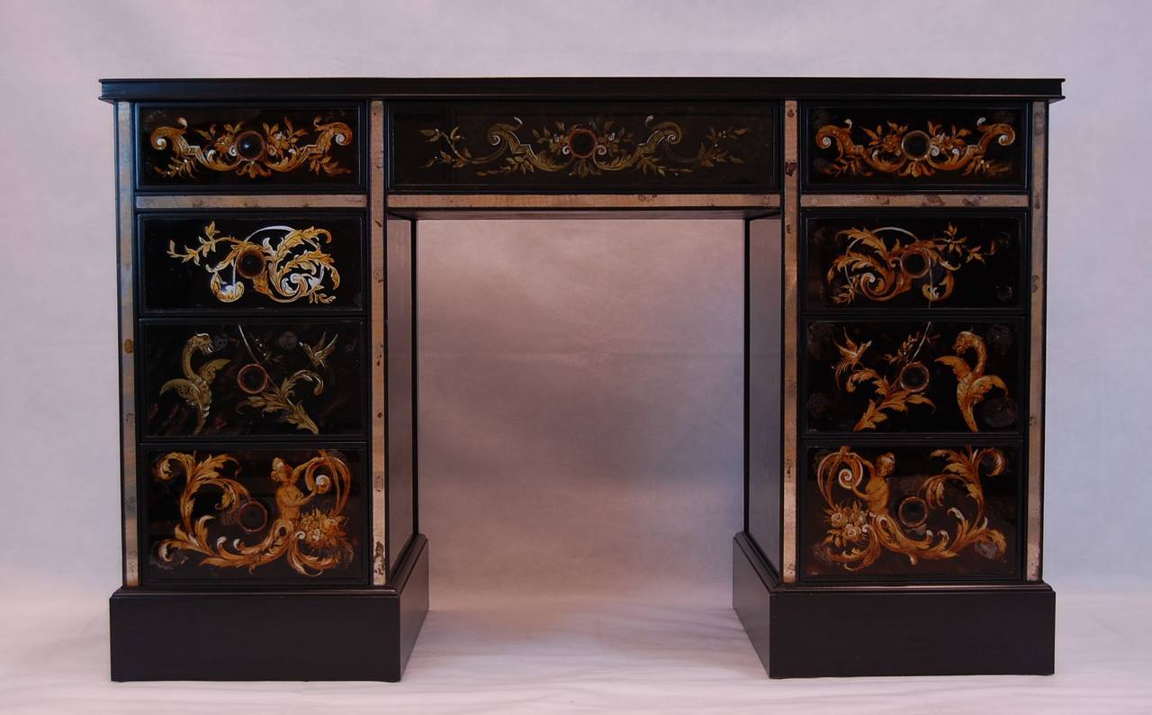 1940s Art Deco églomisé dressing table/desk in very good condition, recently sprayed in black lacquer. The reverse painted decorations are mythological motifs with flying dragons, nude female figures, and horses. The background is all