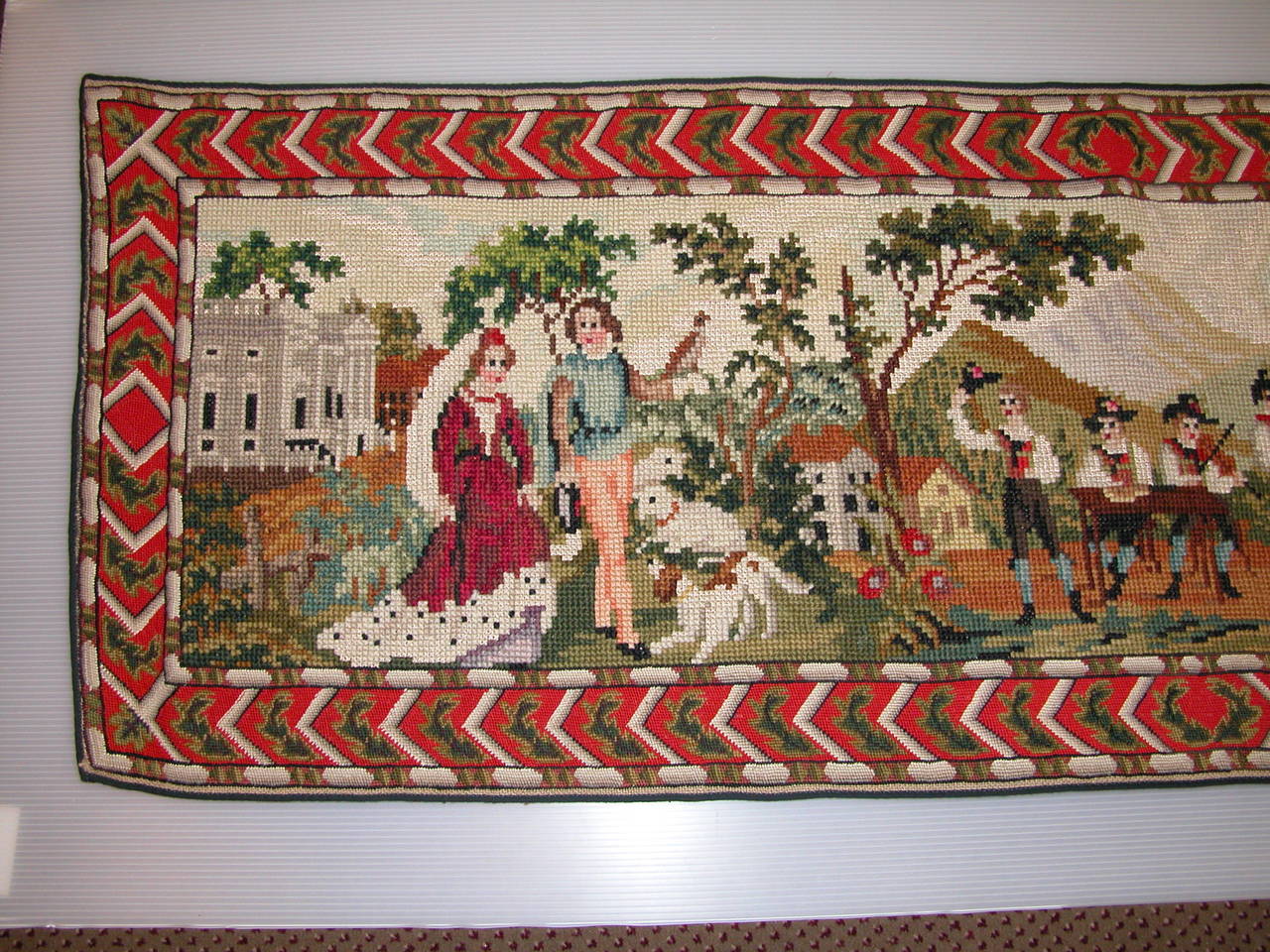 This needlepoint panel measures 26 x 77 and is in amazing condition considering that we feel that it likely dates to the 1920s. We have no idea on where it was made, but it depicts scenes of 19th century country life in what we feel might be