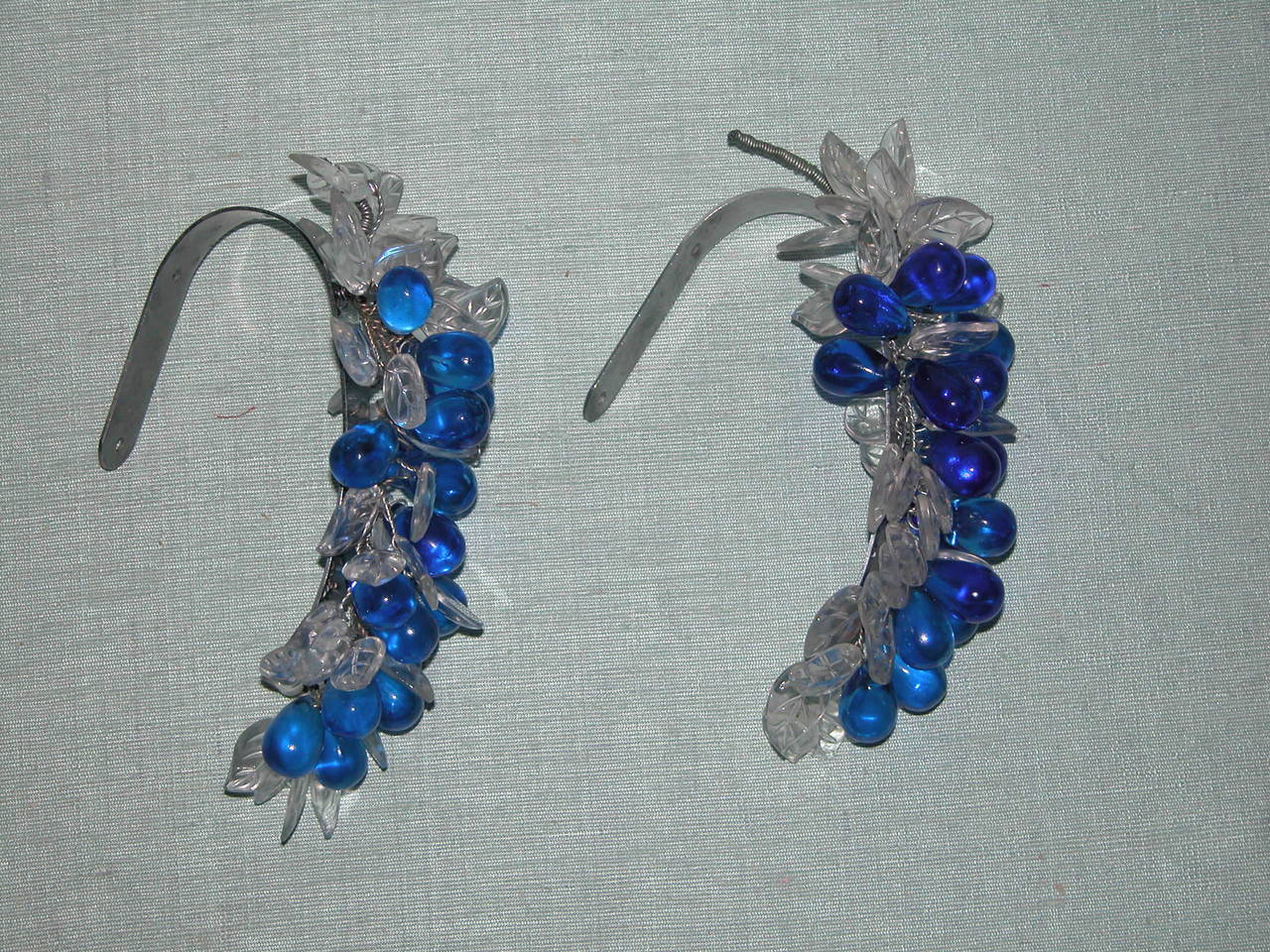 Pair of beautiful Art Deco blue glass grape clusters with clear glass leaves mounted onto chrome brackets.