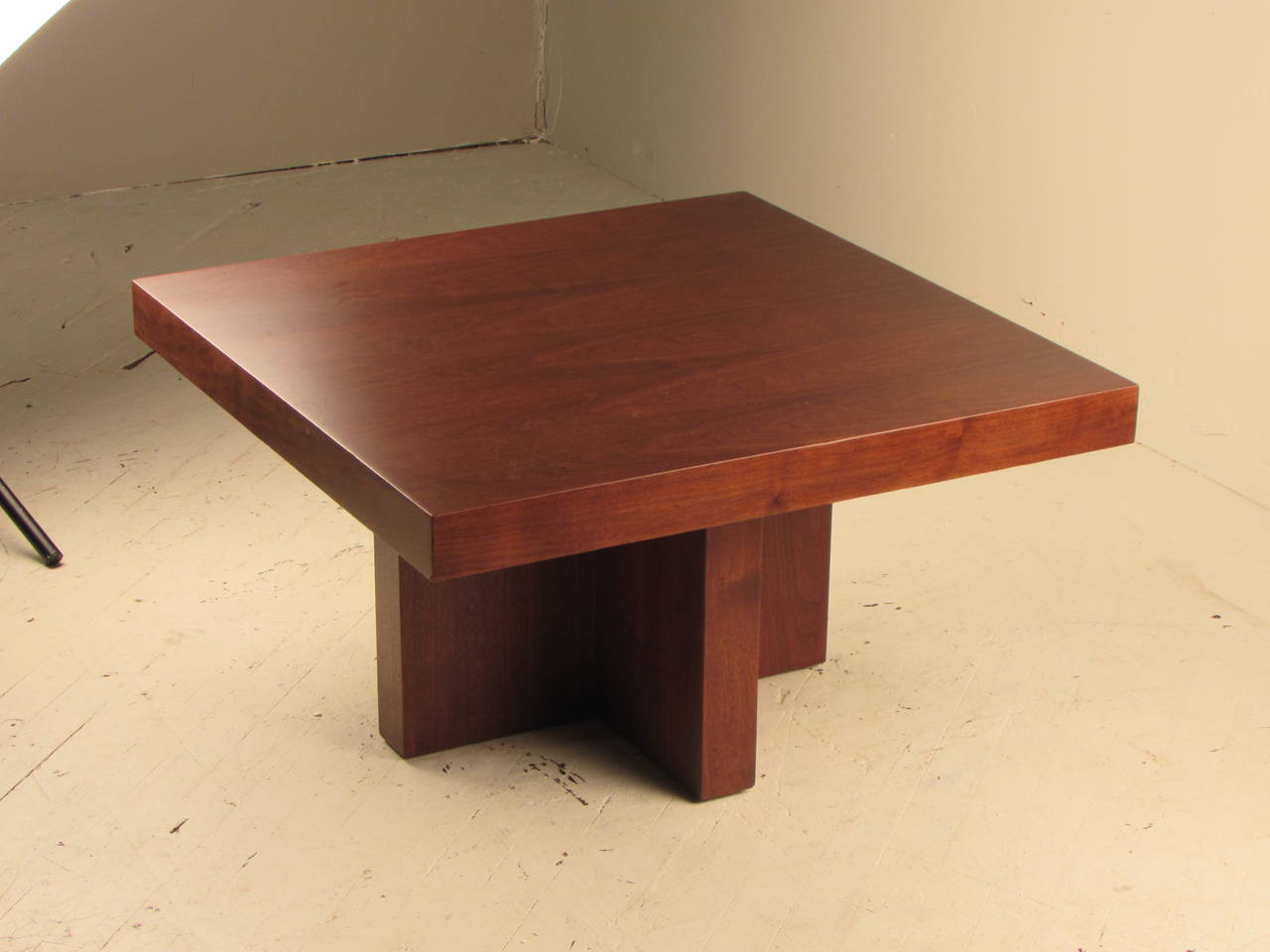 Wonderfully architectural walnut cocktail or coffee table on a cruciform base designed by Milo Baughman for Thayer Coggin. 

This piece has just been professionally reconditioned and is like new. 

Please note: We also have a pair of occasional