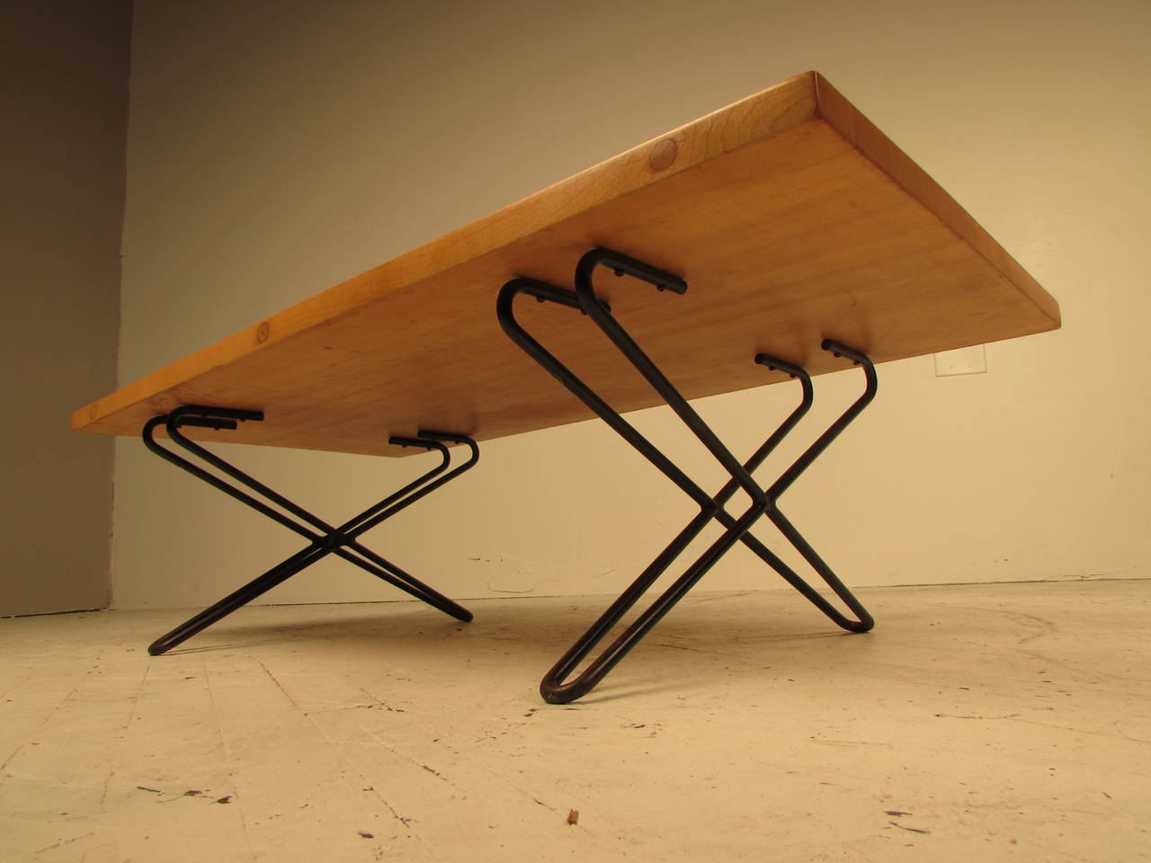 Unique custom coffee table designed by Henry Robert Kann, a NY designer and architect, circa 1953. The top is solid maple and the wrought iron legs are a highly sculptural variation on a hairpin leg, giving the piece a very 1950s French or
