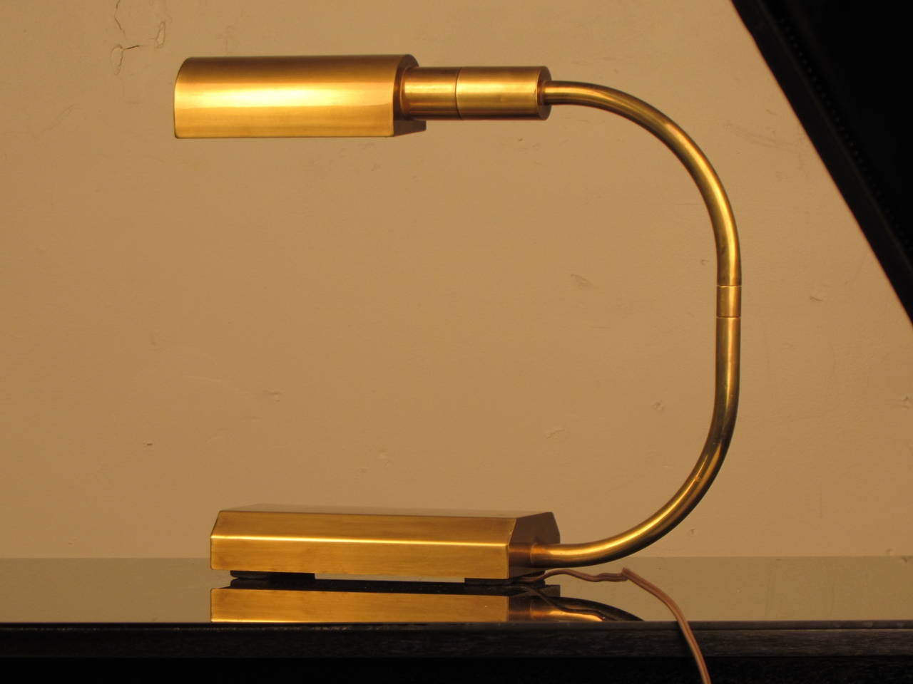 Handsome Bauhaus-inspired brass desk lamp by Chapman. Heavy, heavy, heavy and of impeccable quality! Features a pivoting arm and a pivoting head, giving you options when placing the piece. Would work well as a bedside lamp or piano lamp, also.
