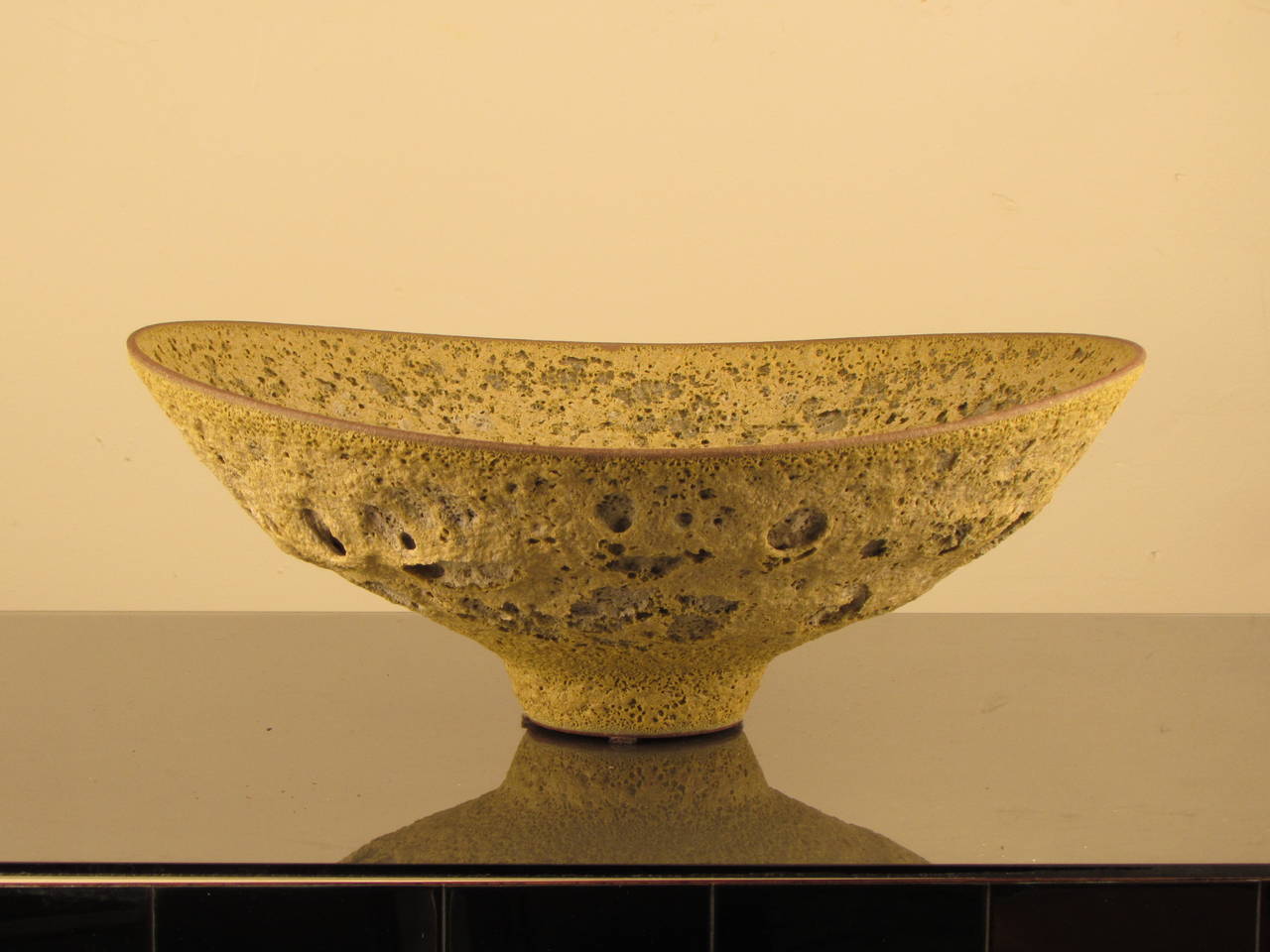 Jaw-dropping glazed stoneware footed bowl by working studio potter, Jeremy Briddell (b.1971). This piece features a spectacular chartreuse crater glaze reminiscent of the work of the Natzlers. Incredibly well-thrown and beautifully balanced;