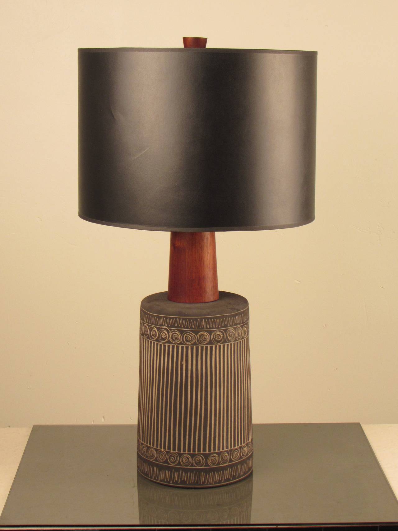 Choice example of the work of Gordon + Jane Martz for Marshall Studios. Lovely matte graphite glaze with intricate incised decoration and original walnut finial. 
Black shade with metallic gold lining is not original to the lamp, but we are happy