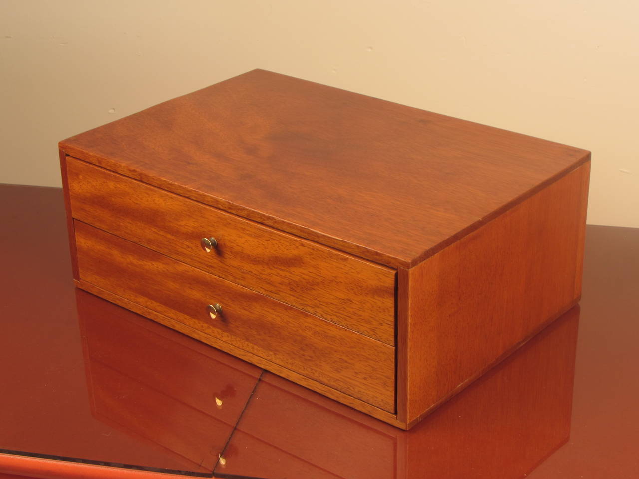 Lovely two drawer mahogany dresser box or jewelry box in the style of Paul McCobb. The drawer pulls are polished brass. This piece has been fully restored.